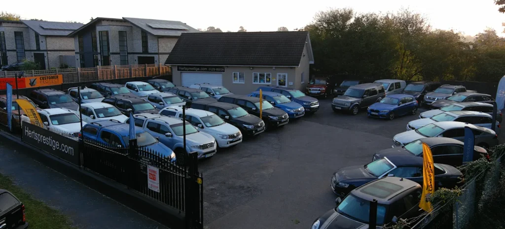 A collection of used mini vans arranged in a parking lot, showcasing a variety of colors and models.