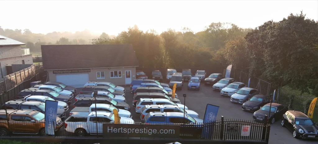 A collection of used mini vans arranged in a parking lot, showcasing a variety of colors and models.